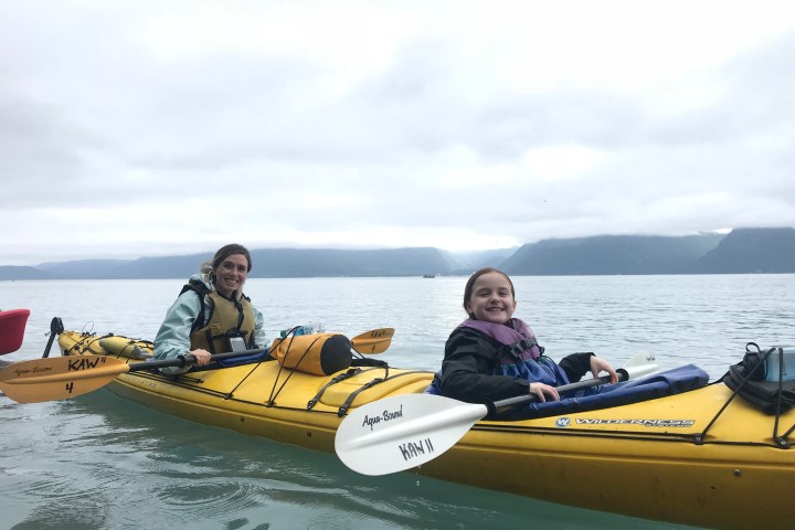 Mother and daughter sharing a double kayak on a private family half day kayak tour