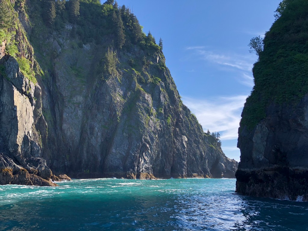 a large body of water with a mountain in the background