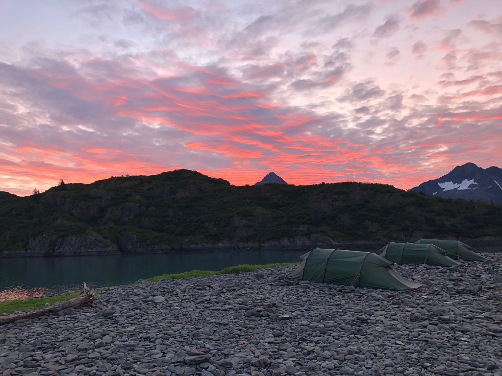a body of water with a mountain in the background