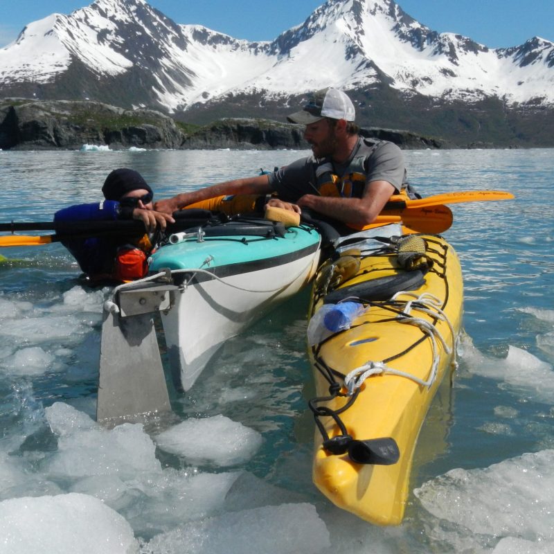 DSCN6797 Kayaker performing a rescue to help two people out of the water into a double kayak